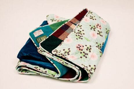 Hemlock printed fabric by Annabel Perrin on the reverse of Brights Harris Tweed patchwork quilt.