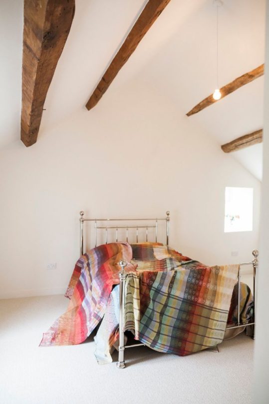 Folklore Fabrics draped over bed All Folkore Fabric designs are available in several glorious colourways.