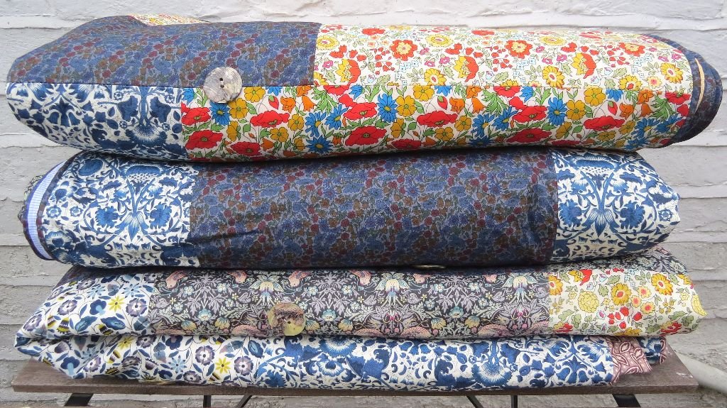 Liberty of London Tana Lawn Summery Patchwork Quilts. Each of the three NEW quilts are all slightly different from their tops and backs. Choose from; William Morris's The Strawberry Thief with pale blue check backing; William Morris's The Strawberry Thief with Sanderson terracotta stylized leaf print backing & Retro Summery brights with golden check backing. Look carefully at the images to make your choice and if you have any further Liberty quilt questions just e-mail me at lisa@quiltsbylisawatson.co.uk