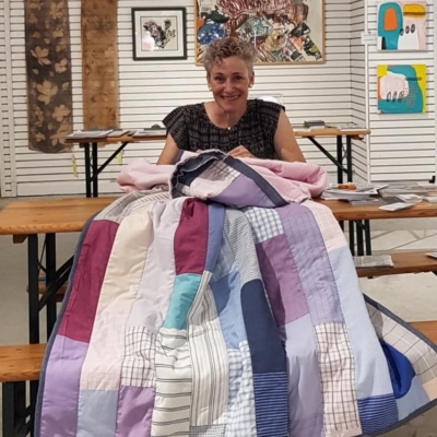 Hand finishing a patchwork shirt quilt